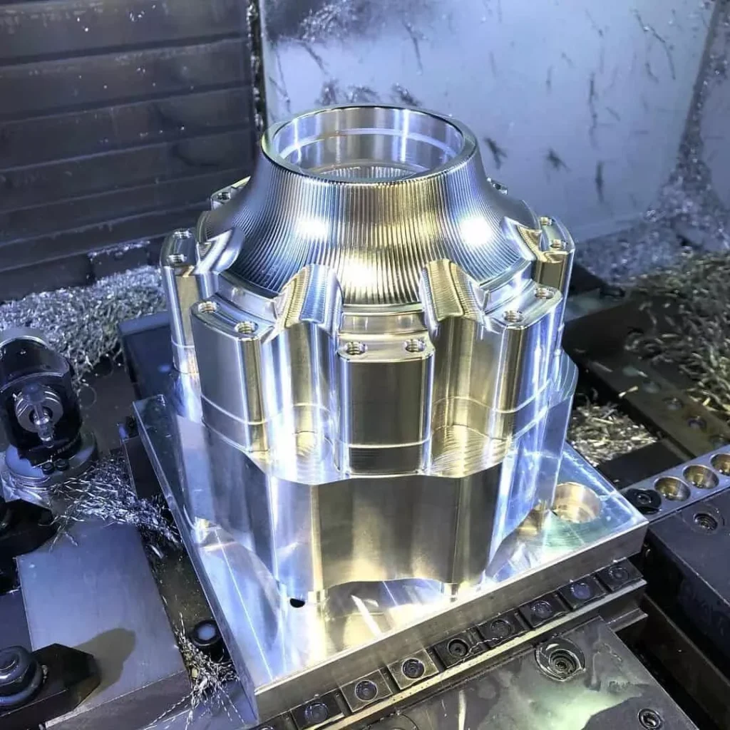 CNC milling machine cutting a metal prototype in a machine shop